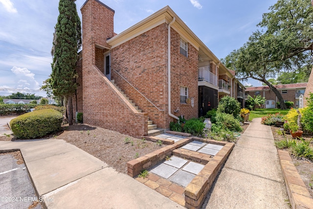 view of side of home with a balcony