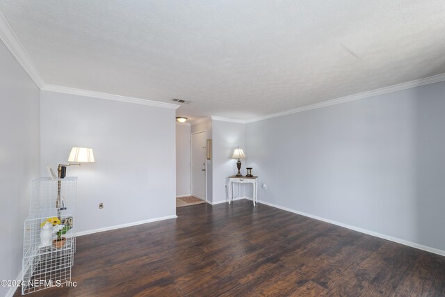 spare room featuring a textured ceiling, wood-type flooring, and crown molding