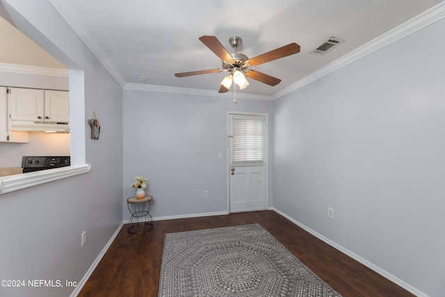 unfurnished room with crown molding, ceiling fan, dark hardwood / wood-style flooring, and a textured ceiling