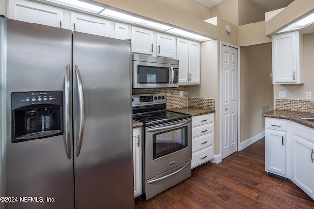 kitchen featuring decorative backsplash, stainless steel appliances, white cabinets, and dark wood-type flooring