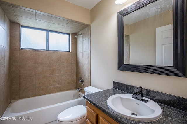 full bathroom with tiled shower / bath combo, toilet, and vanity