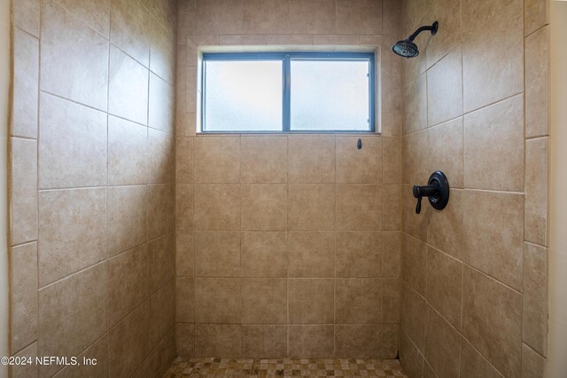 bathroom with tiled shower