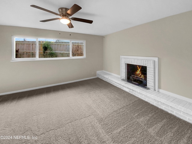 unfurnished living room featuring a fireplace, ceiling fan, and carpet floors