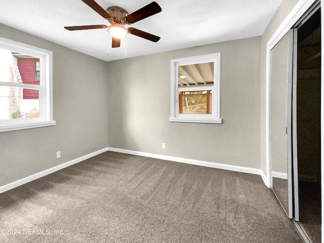 unfurnished bedroom with carpet floors, a closet, and ceiling fan