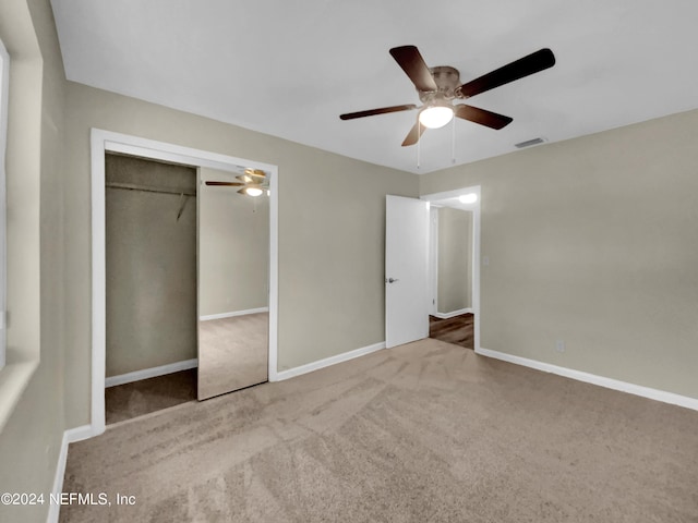 unfurnished bedroom featuring a closet, carpet flooring, and ceiling fan