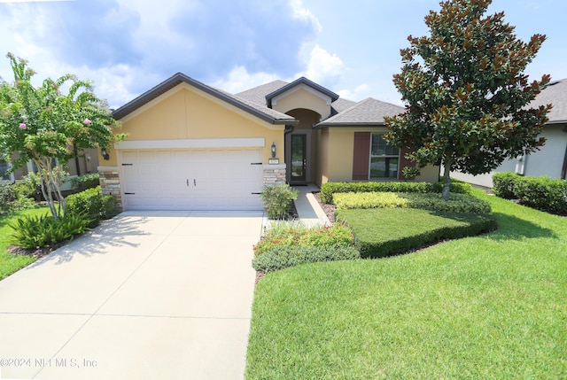 view of front of home featuring a garage and a front lawn