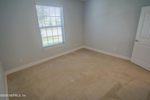 empty room featuring light carpet