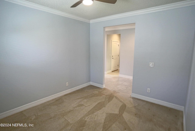 carpeted empty room with crown molding and ceiling fan