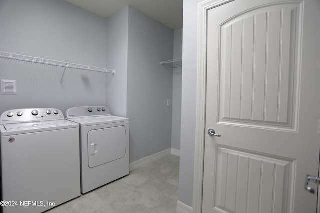 washroom with washer and dryer