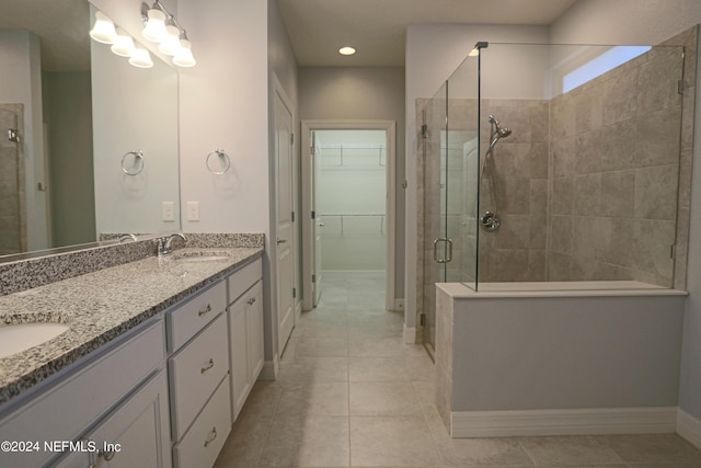 bathroom featuring vanity, tile patterned flooring, and a shower with door