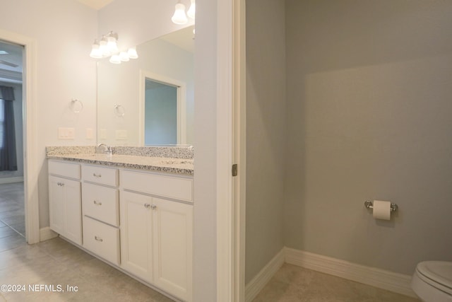 bathroom with tile patterned floors, toilet, and vanity