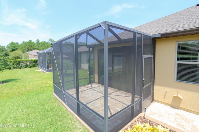 exterior space with a patio and glass enclosure