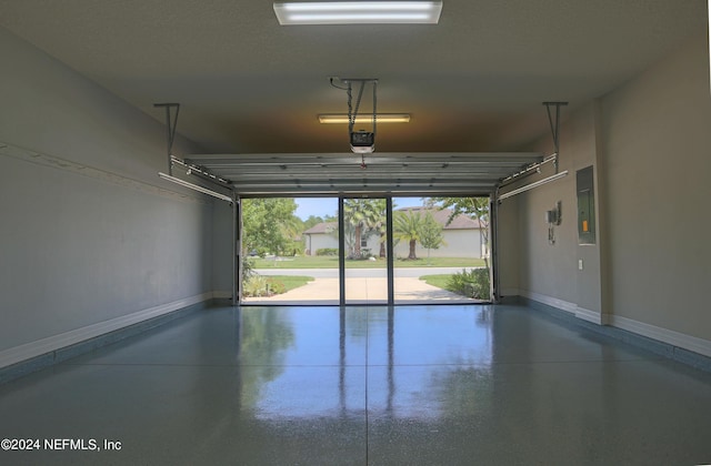 garage featuring a garage door opener and electric panel