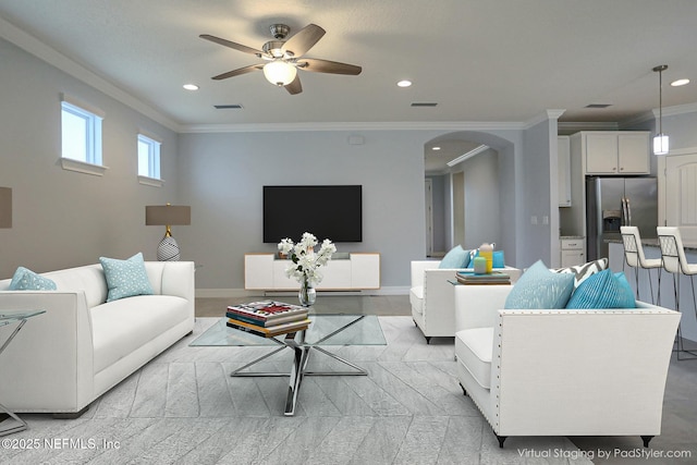 living room featuring ornamental molding and ceiling fan