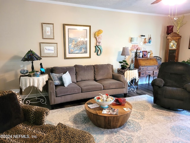 living room with hardwood / wood-style flooring, ornamental molding, and ceiling fan