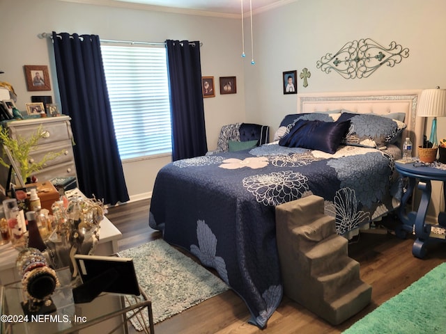 bedroom featuring ornamental molding and hardwood / wood-style floors