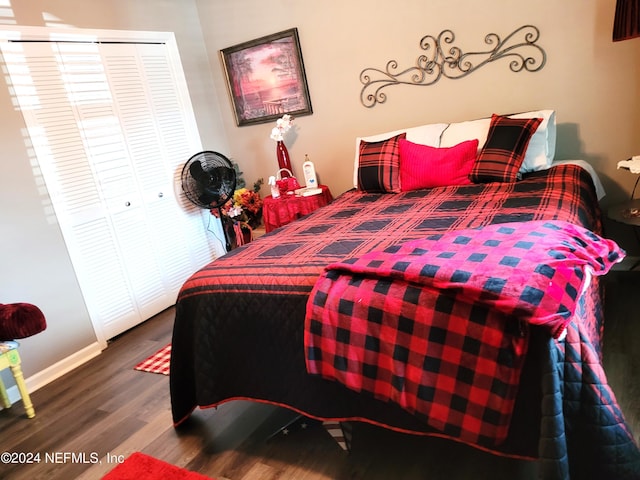 bedroom with hardwood / wood-style floors and a closet