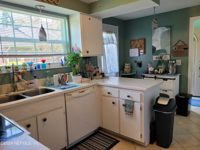 kitchen with hanging light fixtures, dishwasher, sink, and white cabinetry