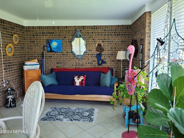 living room with brick wall and light tile patterned floors