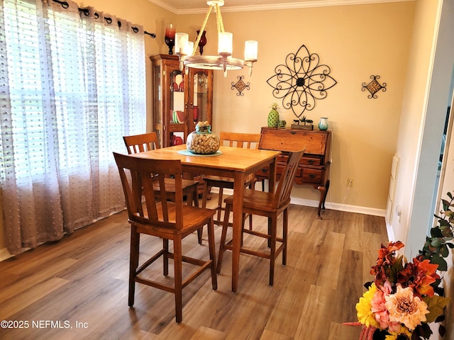 9252 San Jose Blvd Unit 4301, Jacksonville, FL 32257 - dining area with light wood finished floors, a chandelier, and ornamental molding