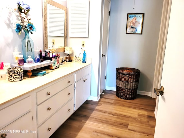 9252 San Jose Blvd Unit 4301, Jacksonville, FL 32257 - bathroom with baseboards, vanity, and wood finished floors