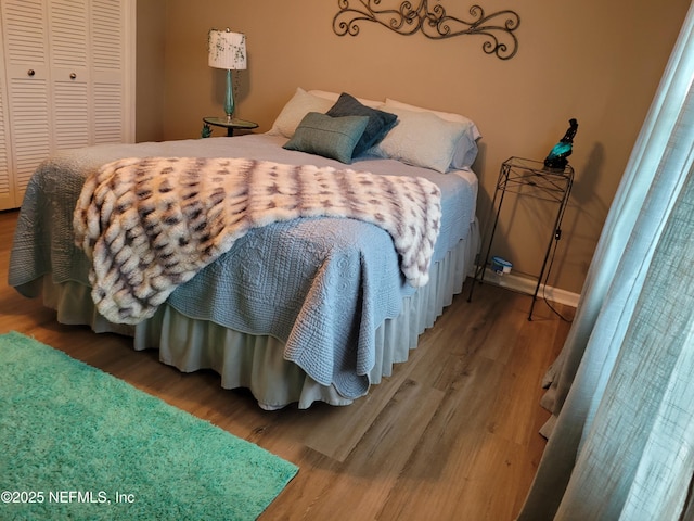 9252 San Jose Blvd Unit 4301, Jacksonville, FL 32257 - bedroom featuring baseboards, wood finished floors, and a closet