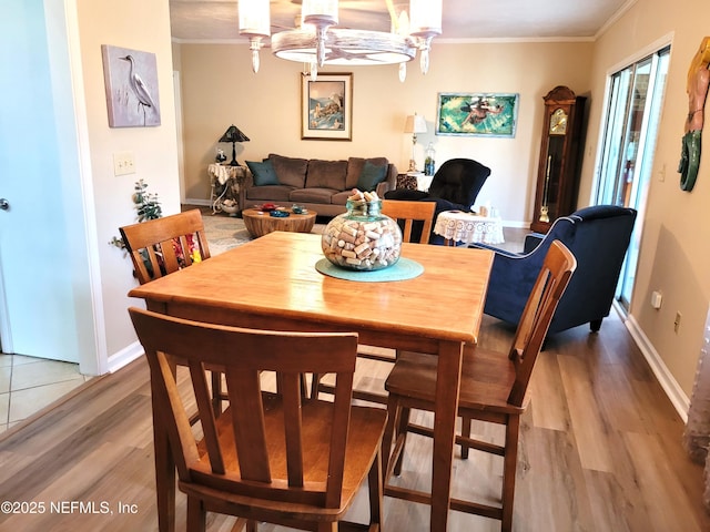 9252 San Jose Blvd Unit 4301, Jacksonville, FL 32257 - dining space featuring baseboards, an inviting chandelier, light wood-style floors, and crown molding