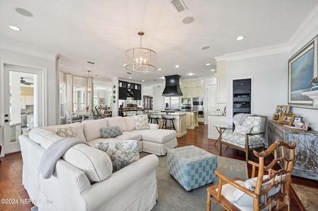 living room with a chandelier, visible vents, ornamental molding, and dark wood-style floors