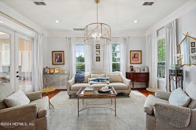 living room with crown molding, visible vents, wood finished floors, and french doors