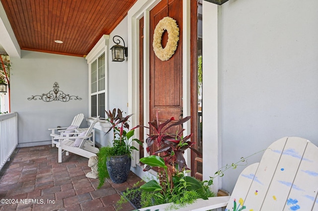 doorway to property featuring stucco siding