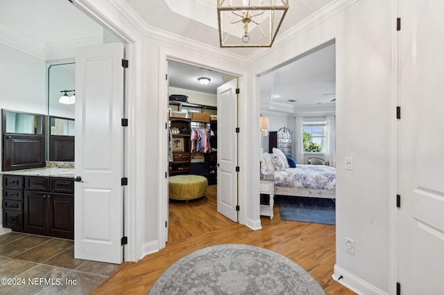 corridor featuring ornamental molding and wood finished floors