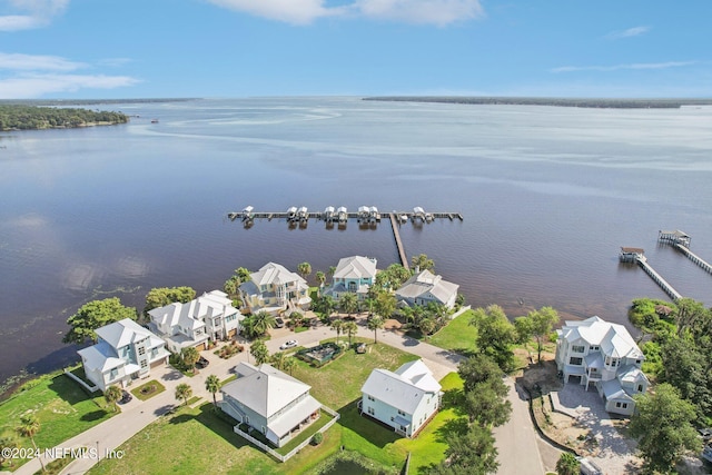 drone / aerial view featuring a water view and a residential view