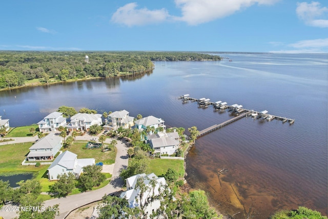 birds eye view of property featuring a water view, a residential view, and a view of trees