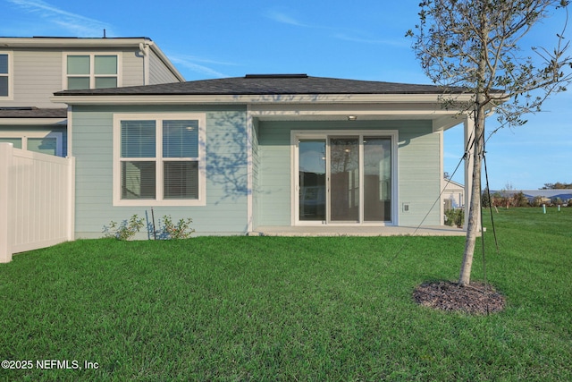 rear view of property featuring a yard