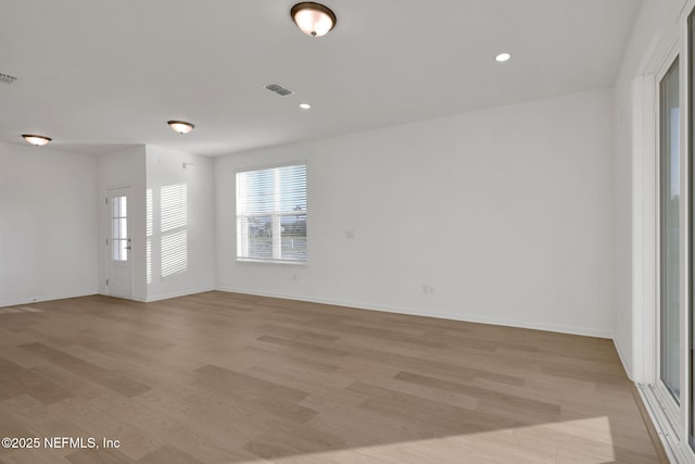 spare room with light wood-type flooring