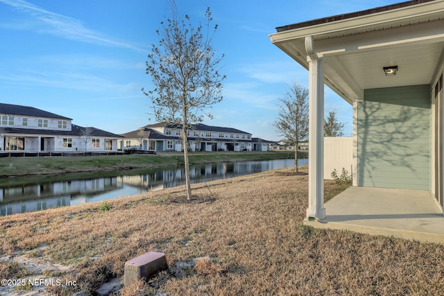 view of yard with a water view and a patio area