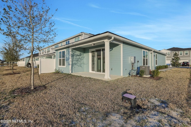 back of property featuring a lawn, central AC, and a patio area