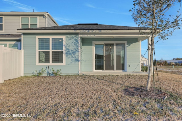 rear view of property with a lawn