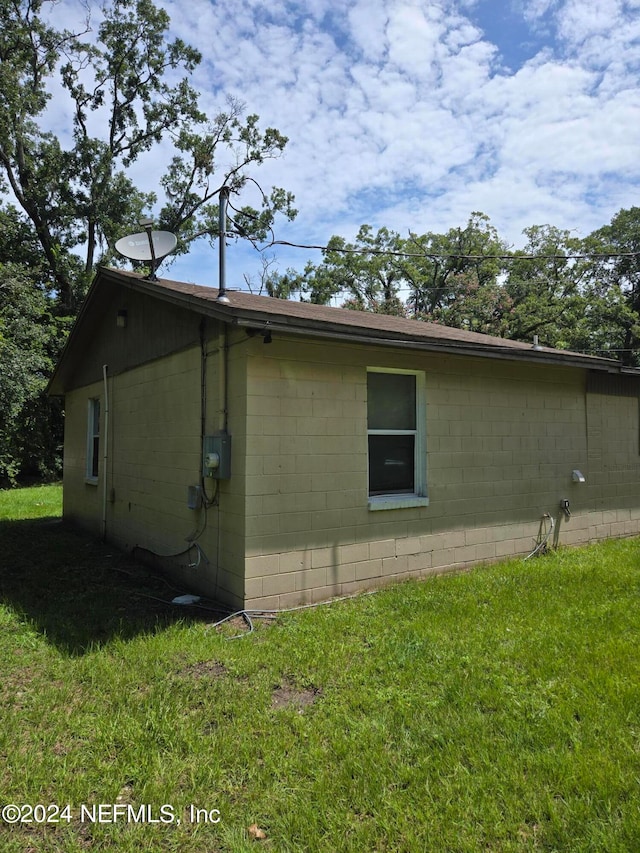 view of side of home featuring a lawn