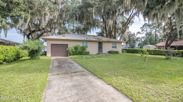 ranch-style home featuring a garage and a front lawn