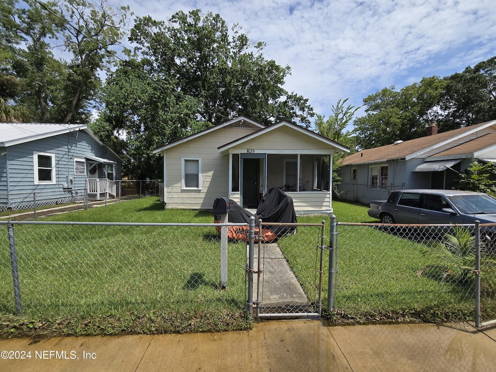 1639 W 16th St, Jacksonville, FL 32209 - bungalow with a gate, a fenced front yard, and a sunroom