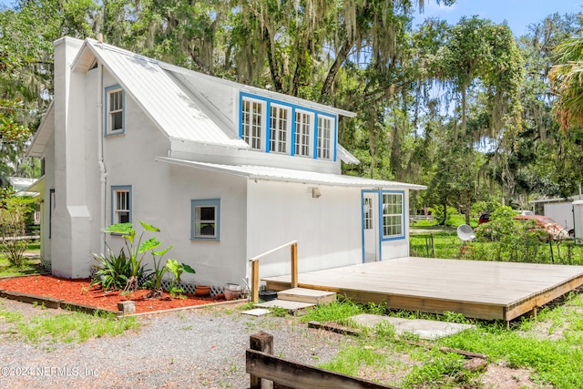 back of property with a wooden deck