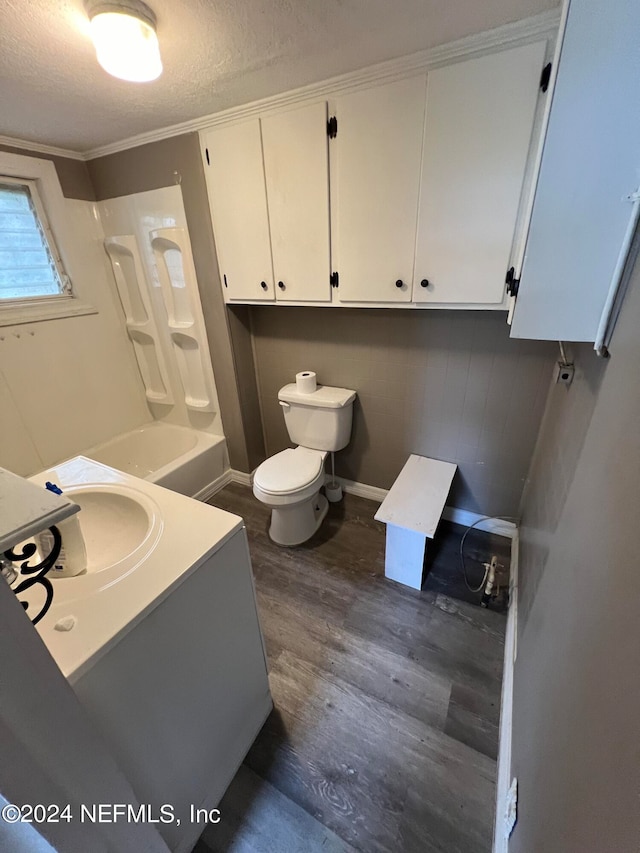 full bathroom with crown molding, shower / washtub combination, a textured ceiling, toilet, and wood-type flooring