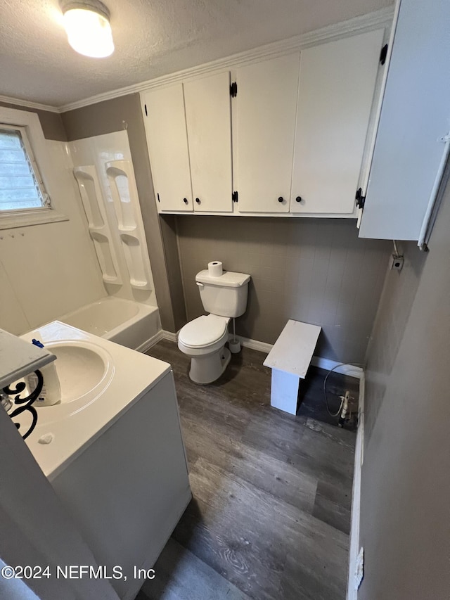 full bathroom with a textured ceiling, toilet, wood finished floors, vanity, and crown molding