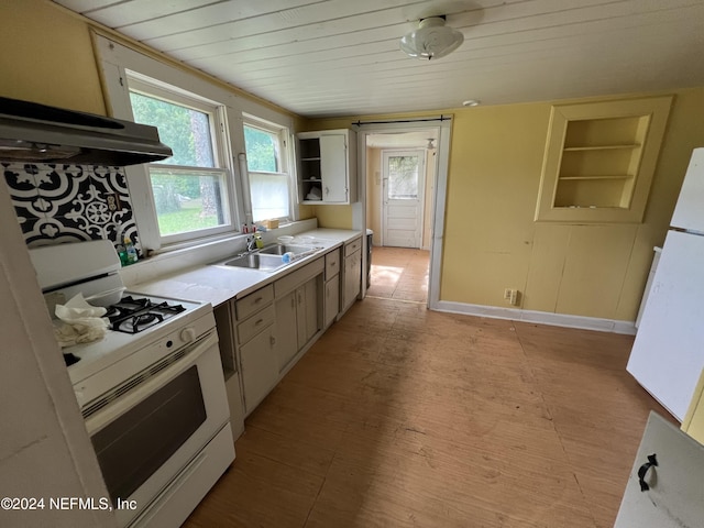 kitchen with white range with gas cooktop, wooden ceiling, light countertops, open shelves, and a sink