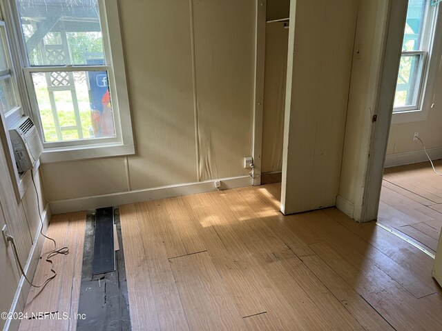 unfurnished bedroom with light wood-type flooring and a closet