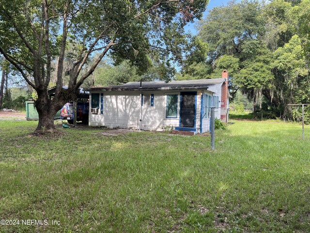 rear view of house with a lawn