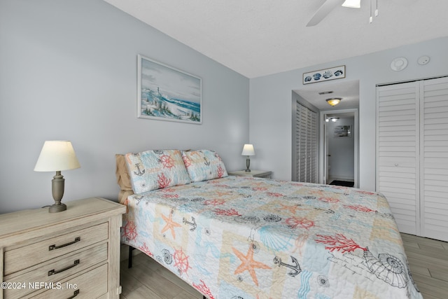 bedroom with ceiling fan and wood finished floors