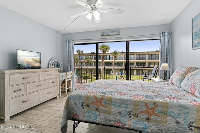 bedroom featuring a textured ceiling, ceiling fan, wood finish floors, and access to exterior