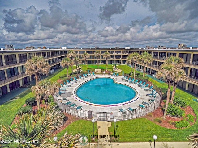 community pool featuring a lawn